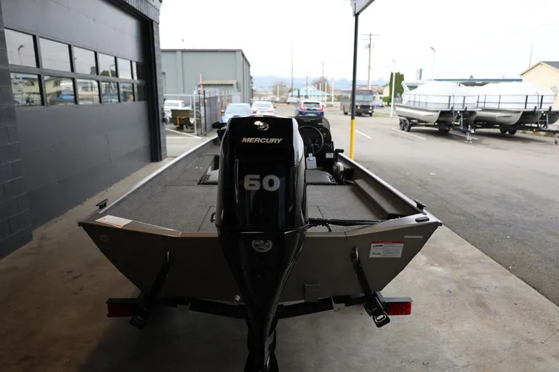 Slide: The Image of 2025 Lowe Skorpion 17 boat with Mercury 60 engine in a parking area. - 7