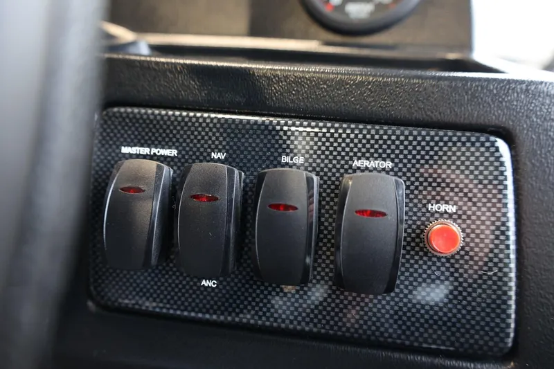 Slide: The Image of Control panel of 2025 Lowe Skorpion 17 boat with switches and horn button. - 9