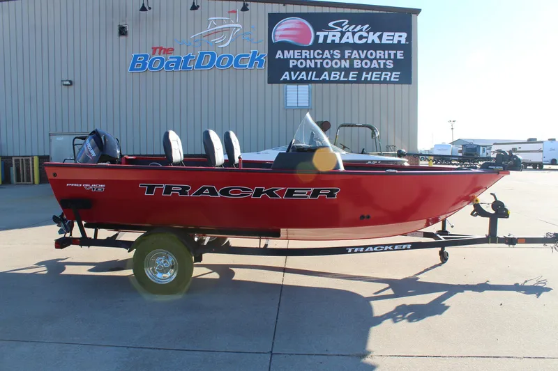 The Image of 2026 Tracker Pro Guide V-16 SC boat on trailer at dealership. - 0