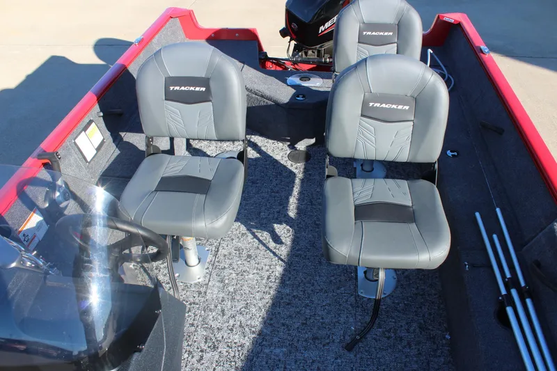 Slide: The Image of 2026 Tracker Pro Guide V-16 SC boat interior with two gray seats and steering console. - 10