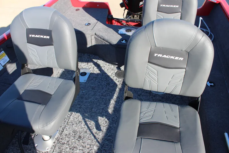 Slide: The Image of 2026 Tracker Pro Guide V-16 SC boat interior with gray seats and carpeted flooring. - 11
