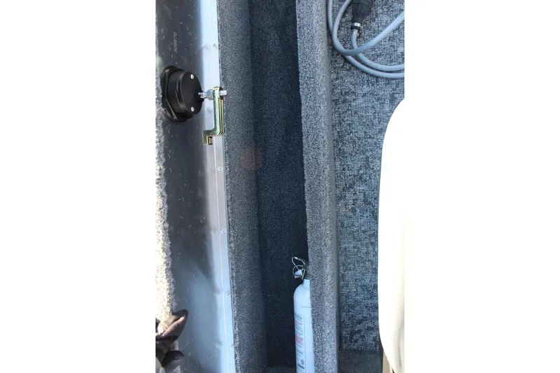 Slide: The Image of Interior view of 2026 Tracker Pro Guide V-16 SC boat with fire extinguisher and cables. - 14