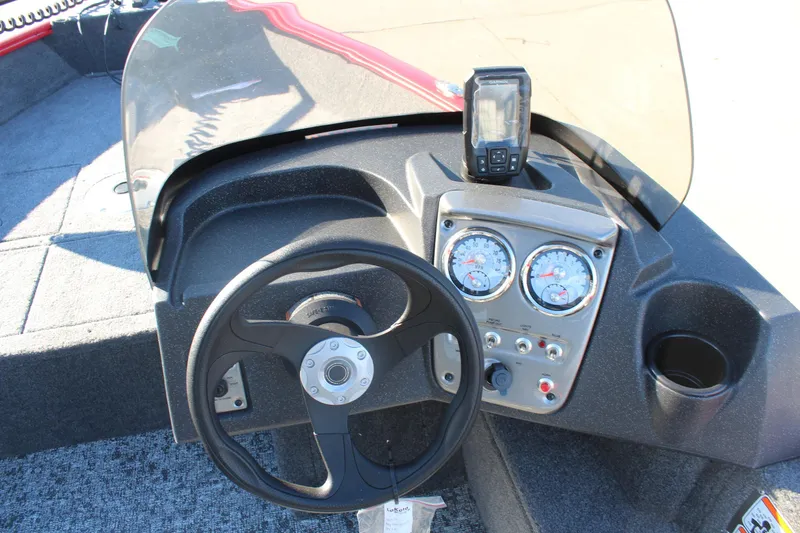 Slide: The Image of 2026 Tracker Pro Guide V-16 SC boat dashboard with steering wheel and gauges. - 15