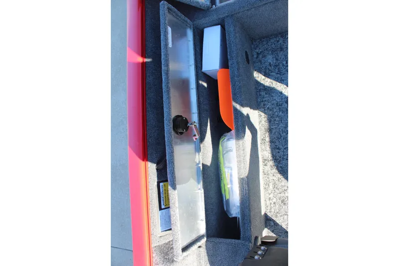 Slide: The Image of Storage compartment of 2026 Tracker Pro Guide V-16 SC boat with safety equipment. - 17