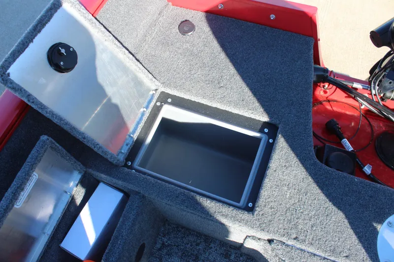Slide: The Image of 2026 Tracker Pro Guide V-16 SC boat interior storage compartment with open lid. - 18