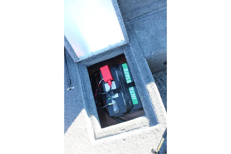 Slide: The Image of Battery compartment of 2026 Tracker Pro Guide V-16 SC boat, featuring Interstate battery. - 19
