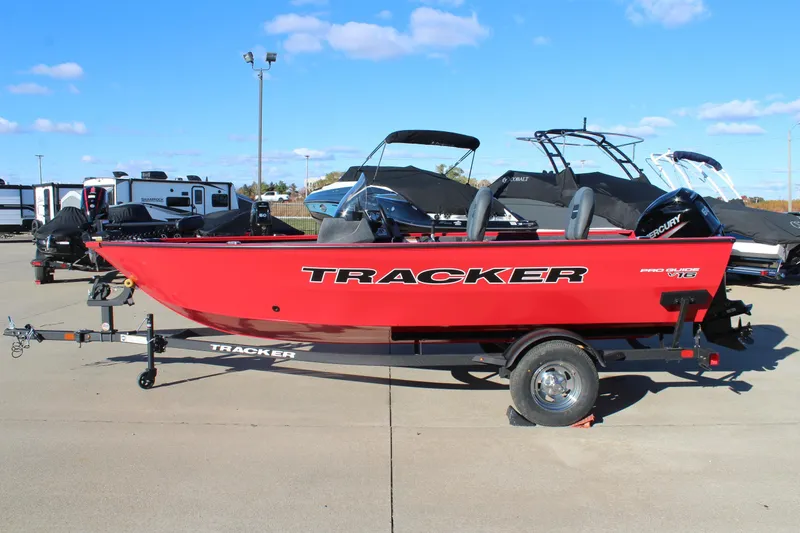 Slide: The Image of 2026 Tracker Pro Guide V-16 SC boat in vibrant red on a trailer. - 4