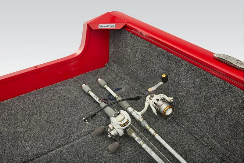 Slide: The Image of Manufacturer Provided Image: 2026 Tracker Pro Guide V-16 SC boat interior with fishing rods on carpeted surface. - 53