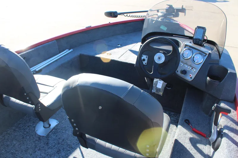 Slide: The Image of 2026 Tracker Pro Guide V-16 SC boat interior with steering console and seating. - 6
