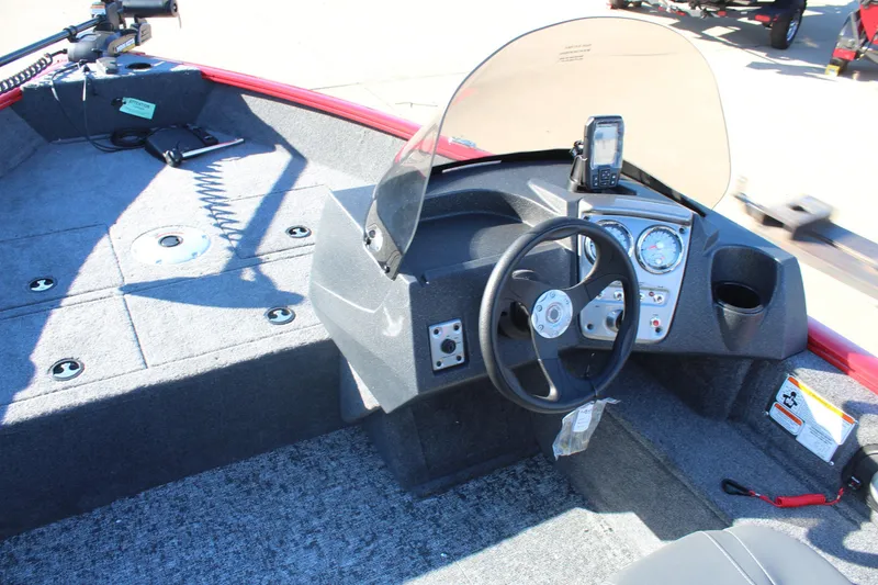 Slide: The Image of 2026 Tracker Pro Guide V-16 SC boat interior with steering console and navigation equipment. - 8