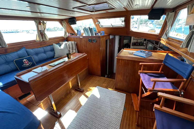 Slide: The Image of 1971 Alden Boothbay Explorer yacht interior with wooden furnishings and blue seating. - 2