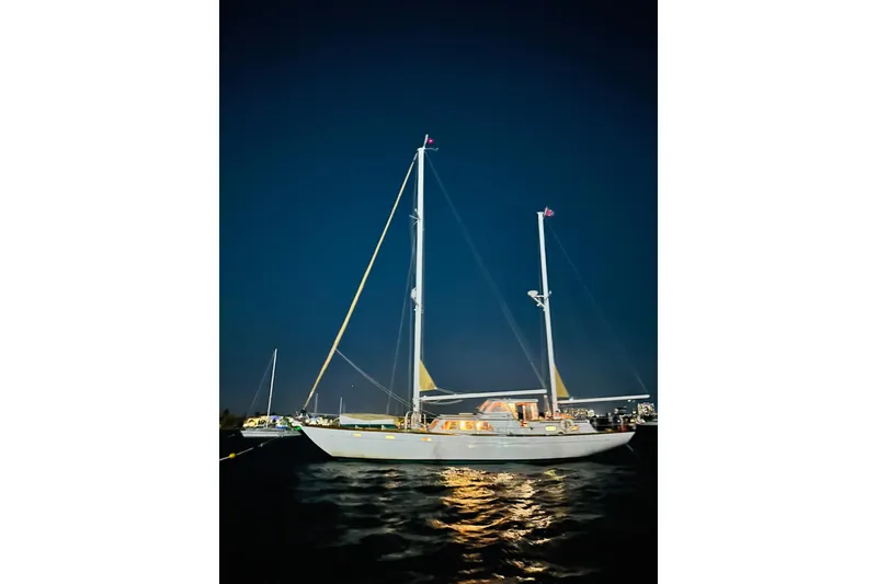 Slide: The Image of 1971 Alden Boothbay Explorer sailboat illuminated at night on calm waters. - 20