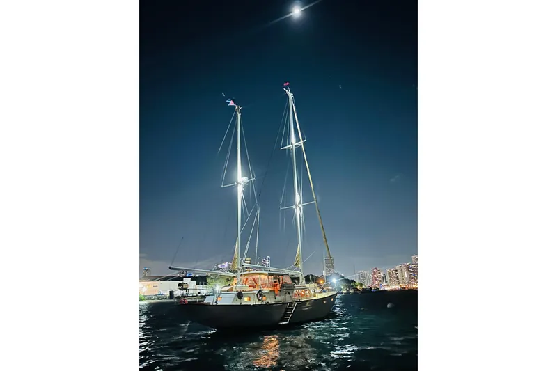 Slide: The Image of Sailboat Alden Boothbay Explorer 1971 illuminated at night on calm waters. - 22