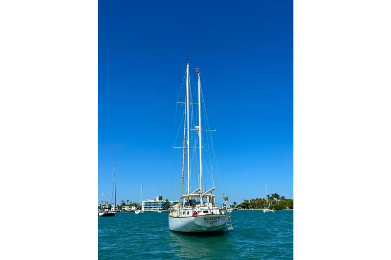 Slide: The Image of Sailboat "Scout" on water, Alden Boothbay Explorer, 1971, under clear blue sky. - 27