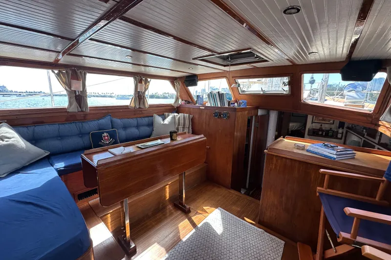 Slide: The Image of Interior of 1971 Alden Boothbay Explorer yacht with wooden furnishings and blue seating. - 35
