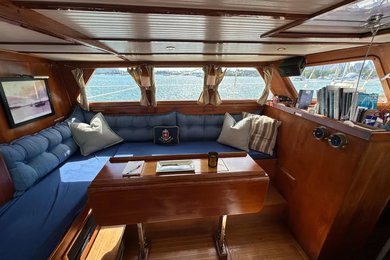 Slide: The Image of Cozy interior of 1971 Alden Boothbay Explorer yacht with blue seating and wooden accents. - 36