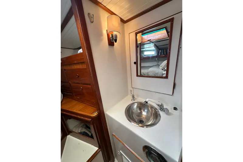 Slide: The Image of 1971 Alden Boothbay Explorer yacht interior with sink, mirror, and wooden cabinetry. - 39
