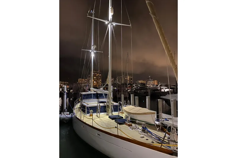 Slide: The Image of 1971 Alden Boothbay Explorer yacht docked at night with city skyline. - 4