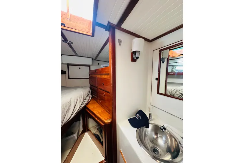 Slide: The Image of 1971 Alden Boothbay Explorer interior with wooden cabinetry and compact sink area. - 45