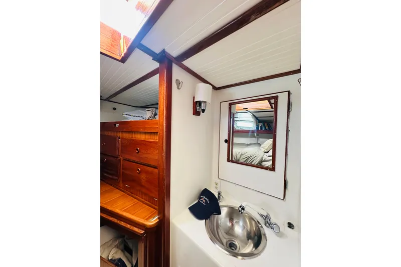 Slide: The Image of Interior of 1971 Alden Boothbay Explorer yacht with wooden cabinetry and stainless steel sink. - 46