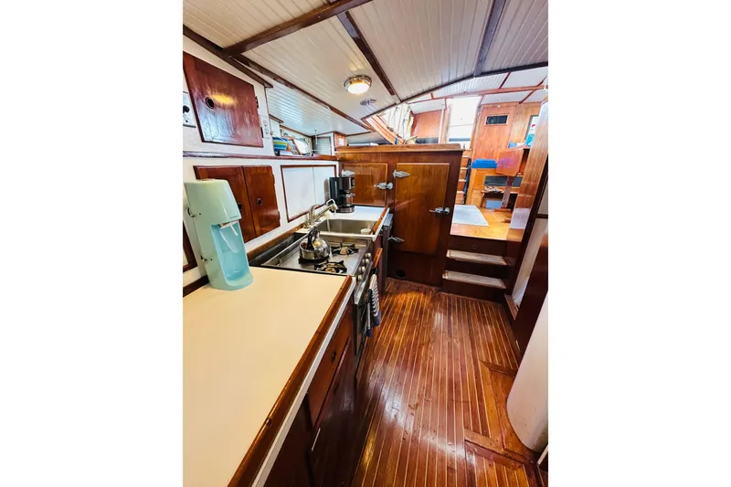 Slide: The Image of Interior of 1971 Alden Boothbay Explorer yacht with wooden cabinetry and compact kitchen. - 49