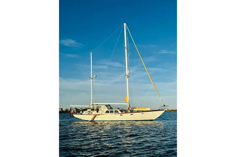 Slide: The Image of Sailboat Alden Boothbay Explorer 1971 on calm water under clear blue sky. - 5