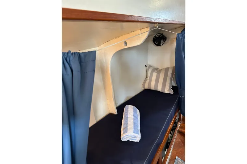 Slide: The Image of Cozy cabin interior of 1971 Alden Boothbay Explorer with striped pillow and rolled towel. - 54