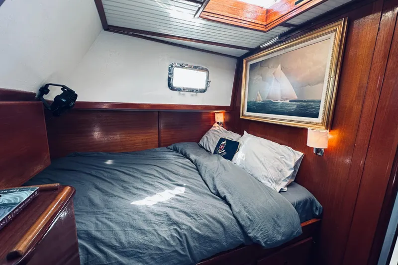 Slide: The Image of Cozy cabin interior of 1971 Alden Boothbay Explorer with wooden paneling and nautical artwork. - 61