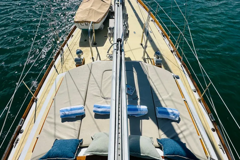 Slide: The Image of Alden Boothbay Explorer 1971 sailboat deck with cushions and towels on a sunny day. - 64