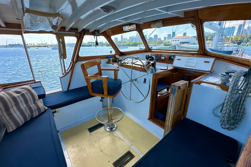 Slide: The Image of Interior of 1971 Alden Boothbay Explorer boat with wooden helm and blue seating. - 70
