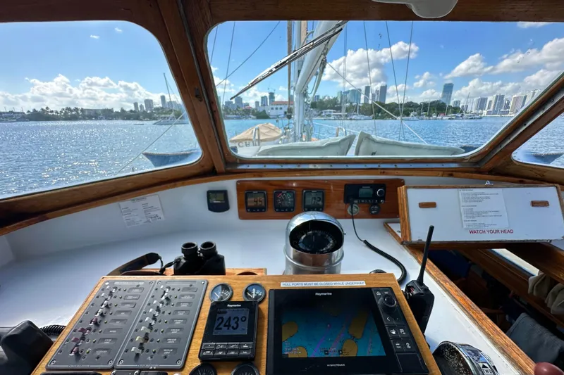 Slide: The Image of Cockpit view of 1971 Alden Boothbay Explorer sailboat with navigation instruments and city skyline. - 75