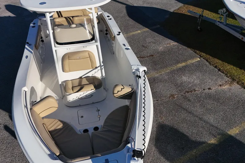 Slide: The Image of 2019 NauticStar 2200XS Offshore boat with beige seating and white deck. - 10