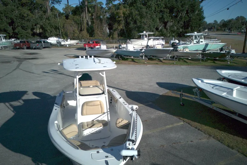 Slide: The Image of 2019 NauticStar 2200XS Offshore boat in a marina with other boats. - 11