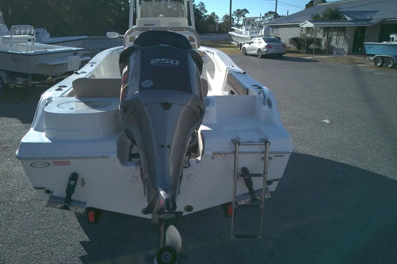 Slide: The Image of 2019 NauticStar 2200XS Offshore boat with Yamaha 250 engine, parked outdoors. - 2