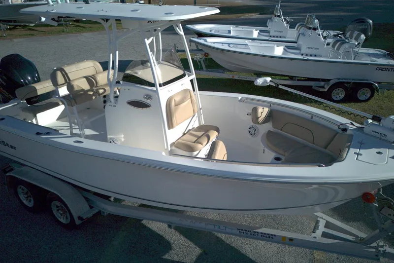 Slide: The Image of 2019 NauticStar 2200XS Offshore boat on trailer, featuring spacious seating and modern design. - 3