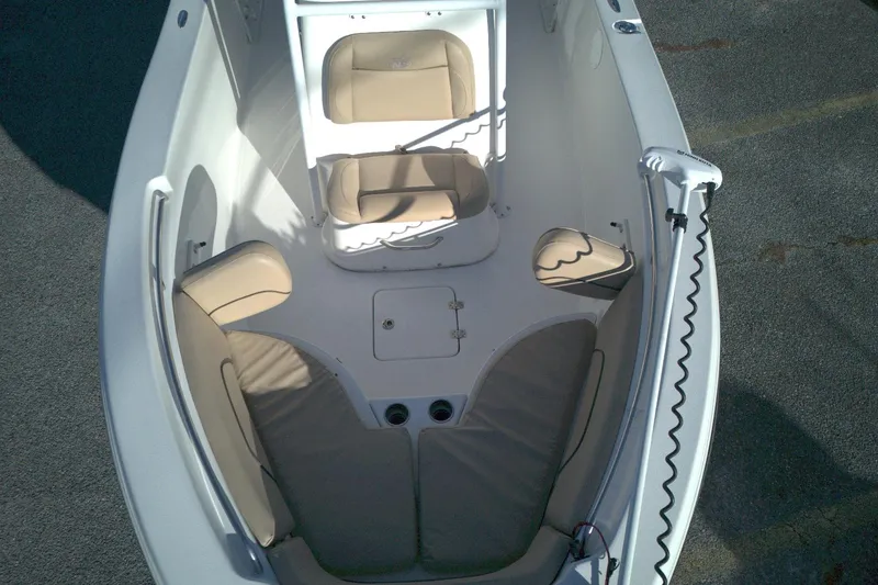 Slide: The Image of 2019 NauticStar 2200XS Offshore boat interior with cushioned seating and storage compartments. - 4