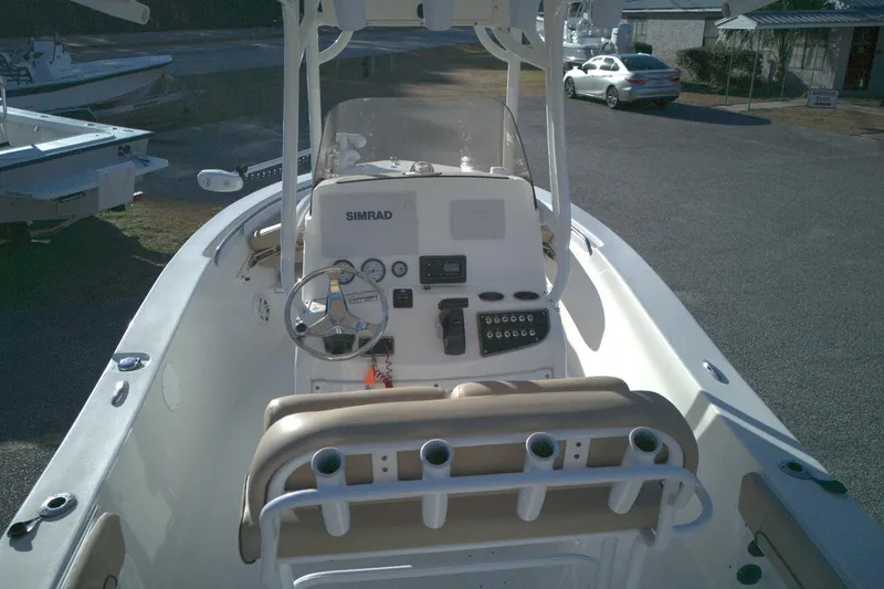 Slide: The Image of 2019 NauticStar 2200XS Offshore boat interior with steering console and seating. - 6