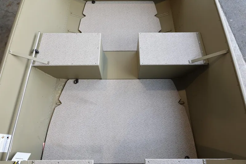 Slide: The Image of 2025 Lund SSV-18 Tiller boat interior with storage compartments and textured flooring. - 10