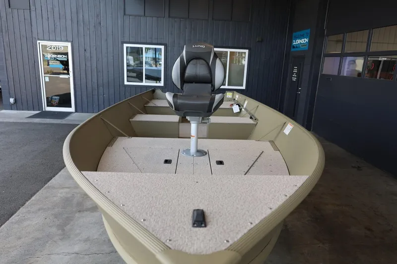Slide: The Image of 2025 Lund SSV-18 Tiller boat displayed indoors, featuring a central seat and spacious deck. - 3