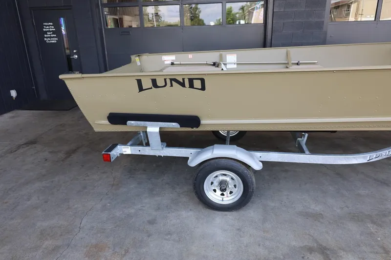 Slide: The Image of 2025 Lund SSV-18 Tiller boat on trailer, parked in a garage. - 4