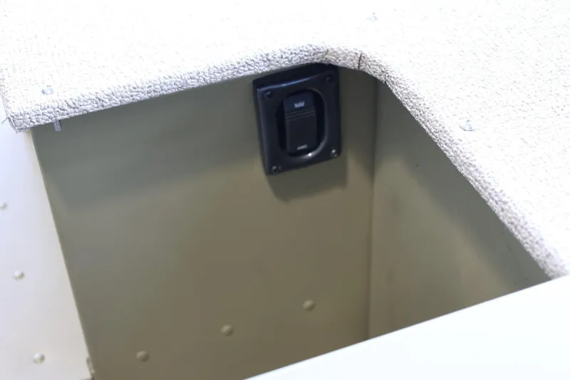 Slide: The Image of 2025 Lund SSV-18 Tiller boat interior with textured surface and switch panel. - 8