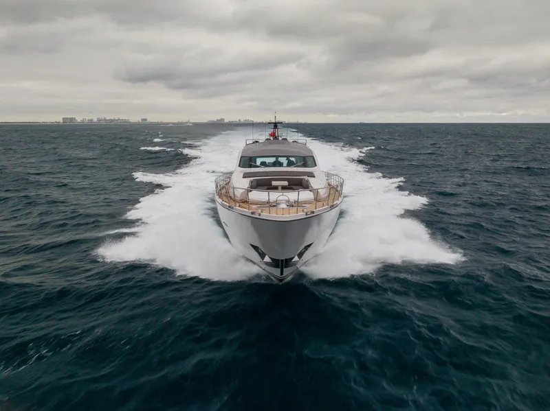 Slide: The Image of Front view of a 2018 Pershing 108 yacht cruising on open water under cloudy skies. - 12