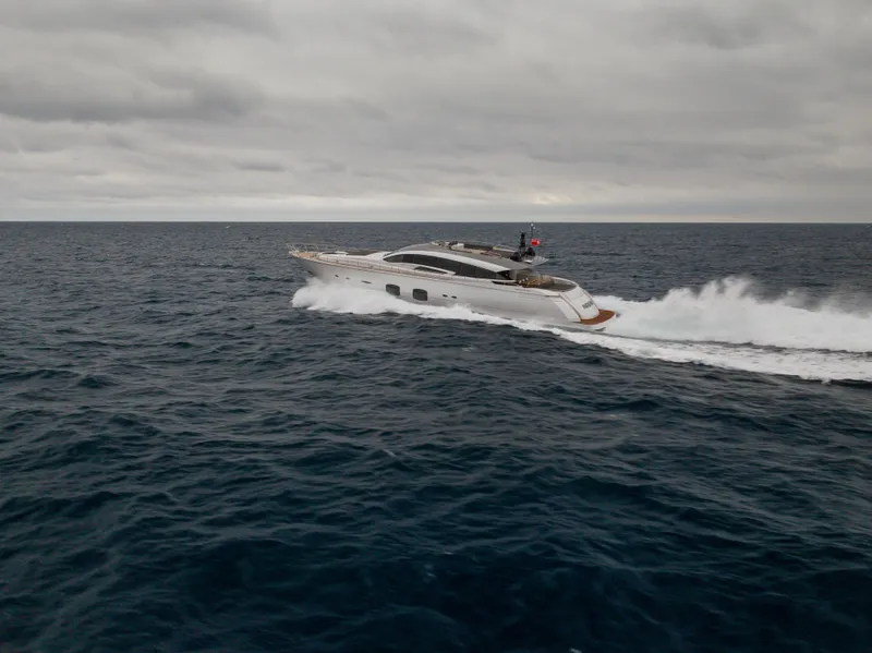 Slide: The Image of 2018 Pershing 108 yacht cruising on open sea under cloudy skies. - 15
