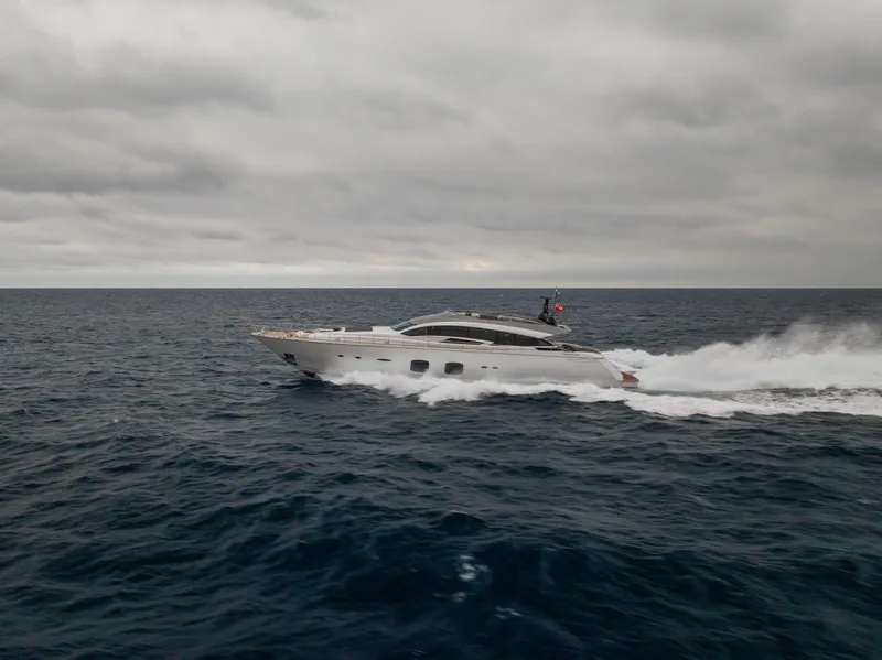 Slide: The Image of 2018 Pershing 108 yacht cruising on open sea under cloudy skies. - 16