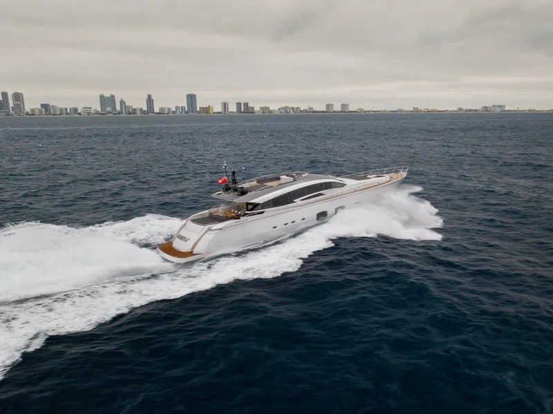 Slide: The Image of 2018 Pershing 108 yacht cruising on open water near city skyline. - 18