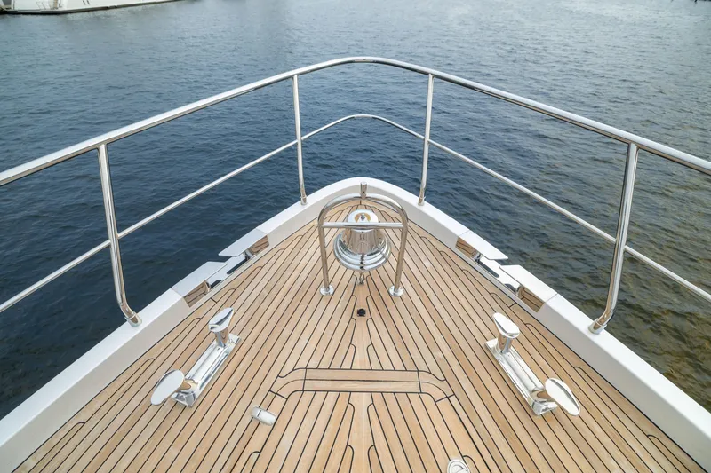 Slide: The Image of Bow of 2018 Pershing 108 yacht with teak deck and stainless steel railings. - 22