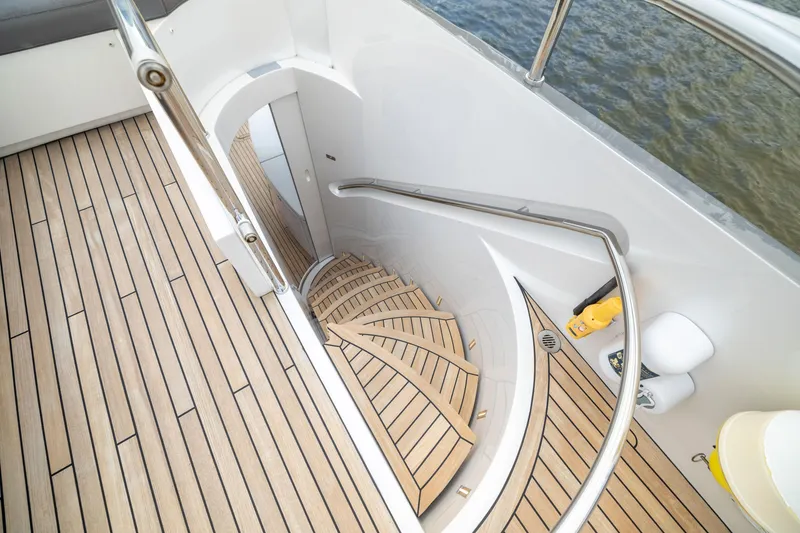 Slide: The Image of Staircase on 2018 Pershing 108 yacht with teak flooring and sleek design. - 24
