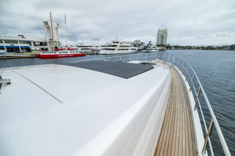 Slide: The Image of 2018 Pershing 108 yacht docked at marina with cityscape background. - 25
