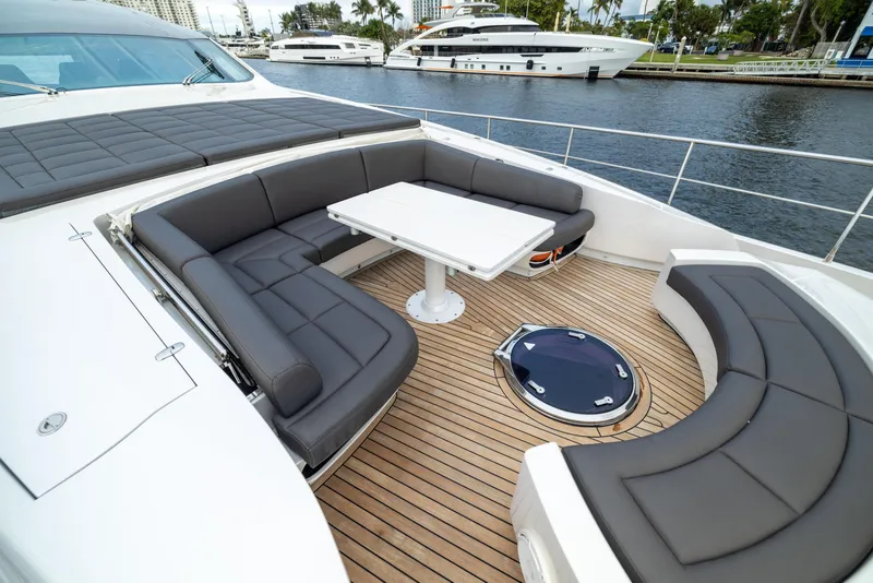 Slide: The Image of Luxurious 2018 Pershing 108 yacht deck with elegant seating and table arrangement. - 27