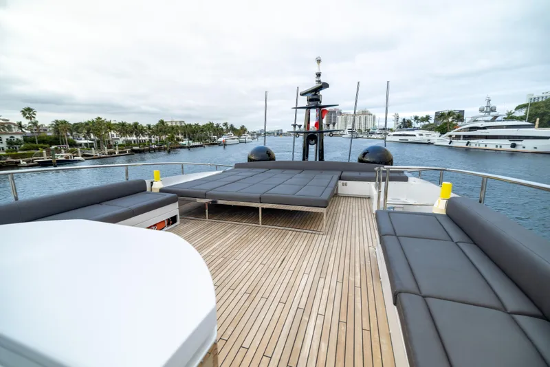 Slide: The Image of Luxurious 2018 Pershing 108 yacht deck with sleek seating and scenic marina view. - 29
